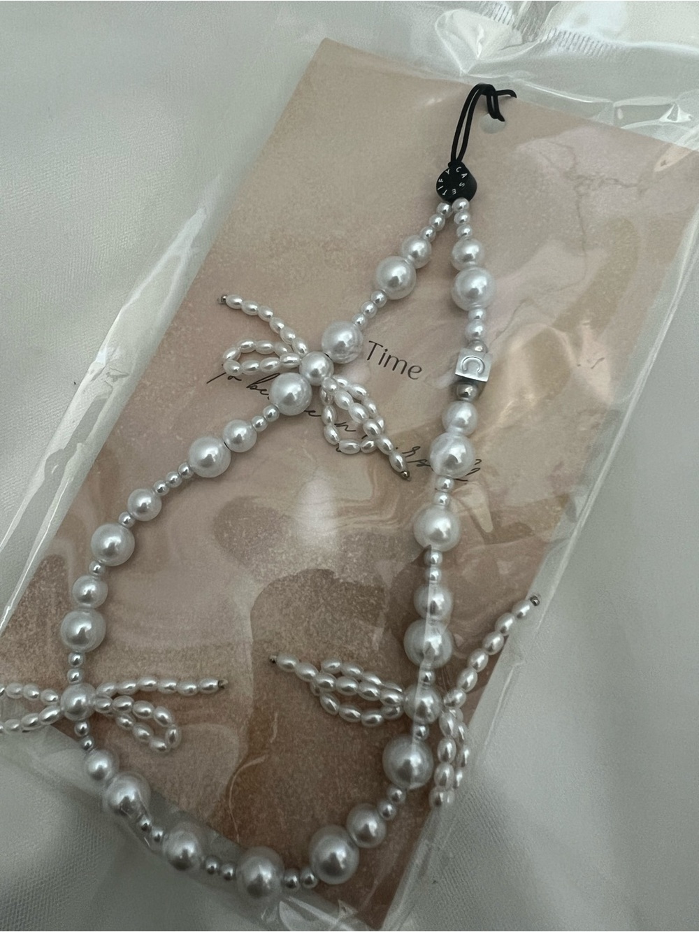 Trendy Pearl Bow Accent White Phone Strap